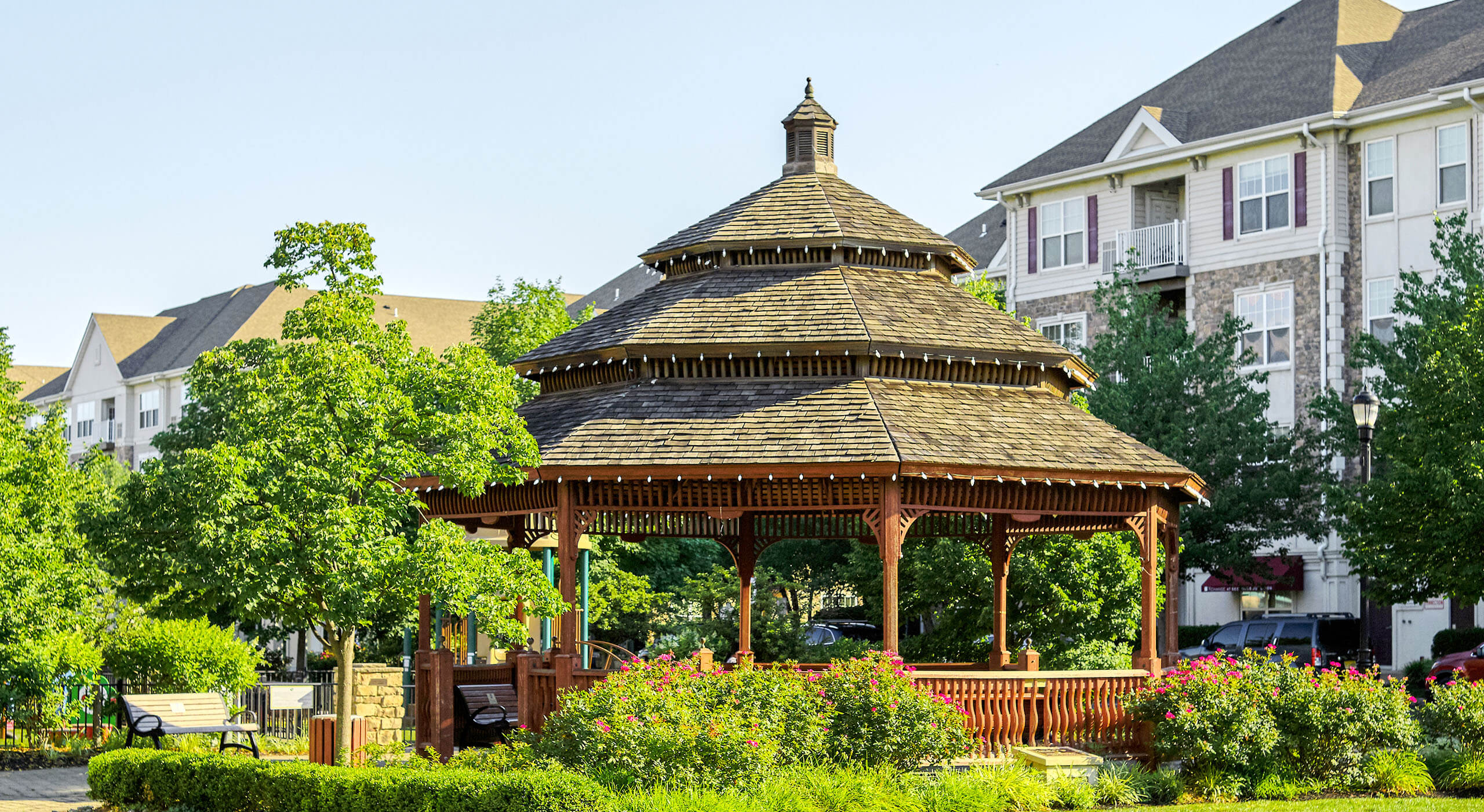 Gazebo surrounded by trees and bushes in the middle of Xchange's community green space