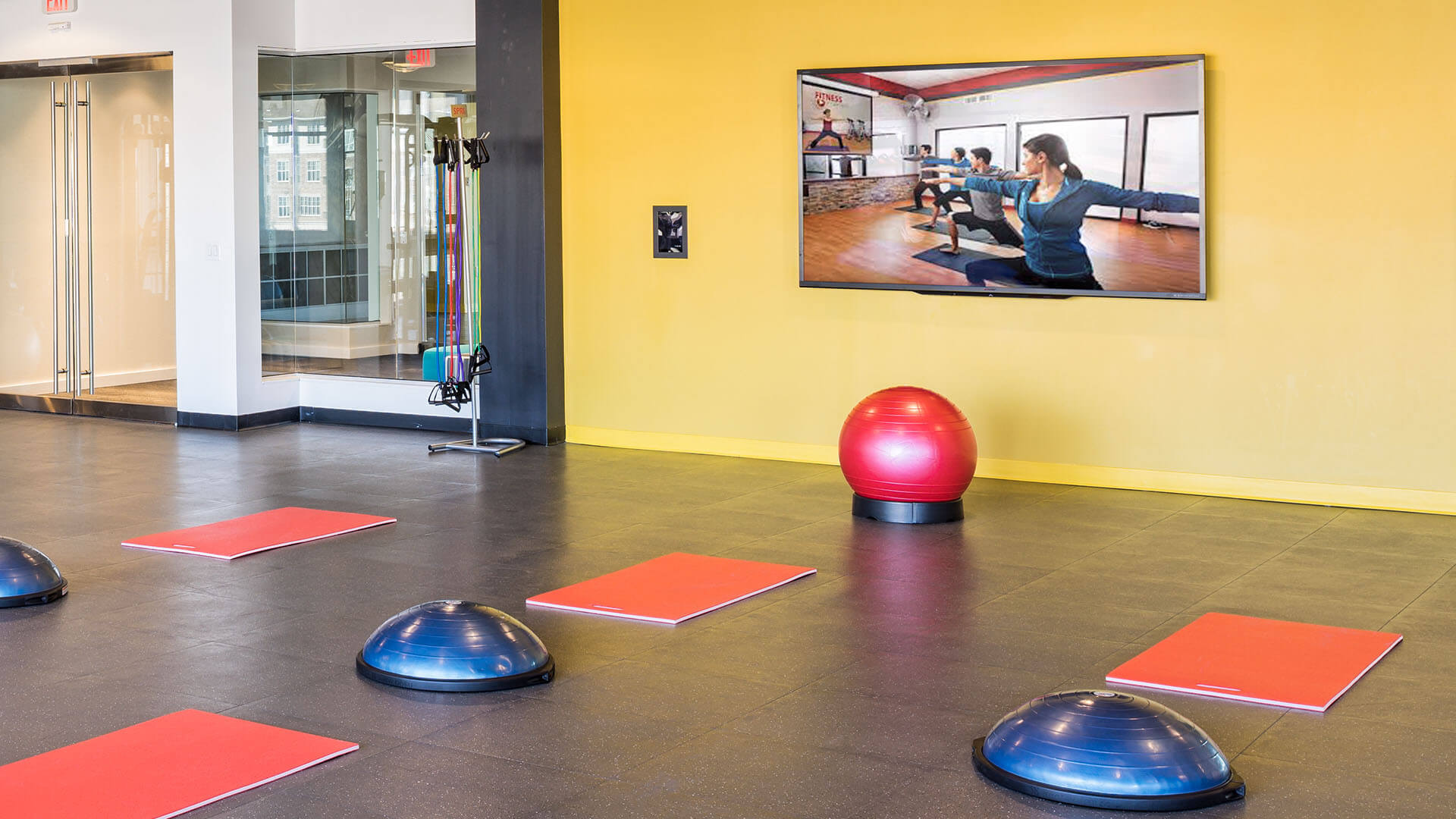 Fitness-on-demand studio with a kiosk pre-programmed with popular virtual classes